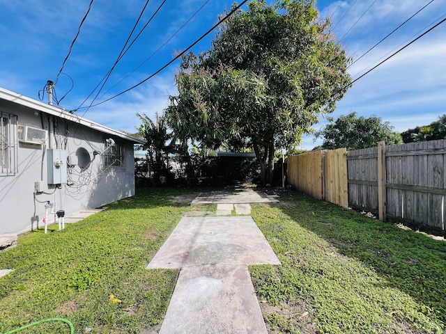 view of yard featuring an AC wall unit