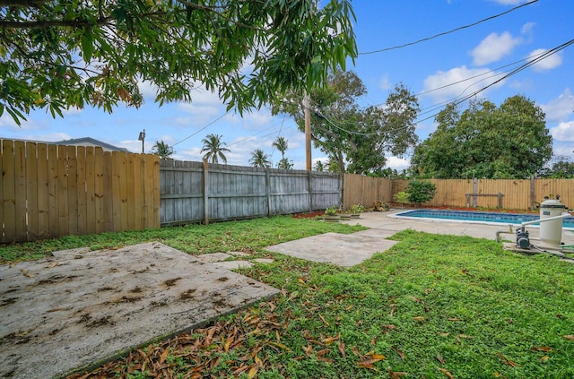 view of yard with a fenced in pool, a fenced backyard, and a patio