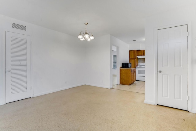 unfurnished living room with light speckled floor, baseboards, visible vents, and a notable chandelier