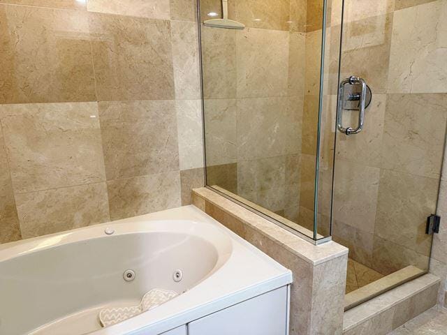 bathroom featuring separate shower and tub