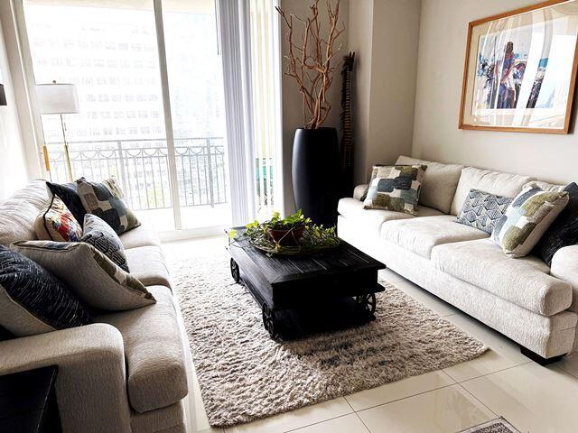 tiled living room featuring a healthy amount of sunlight