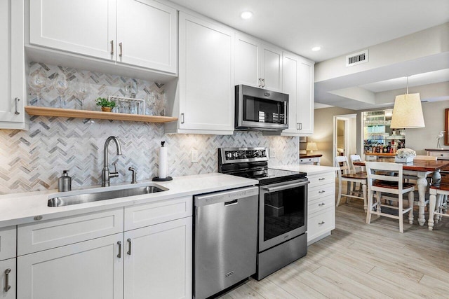 kitchen featuring white cabinetry and appliances with stainless steel finishes