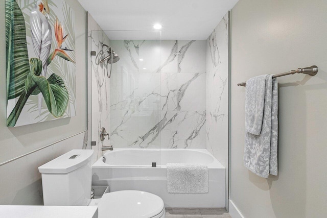 full bathroom featuring vanity, tiled shower / bath combo, and toilet