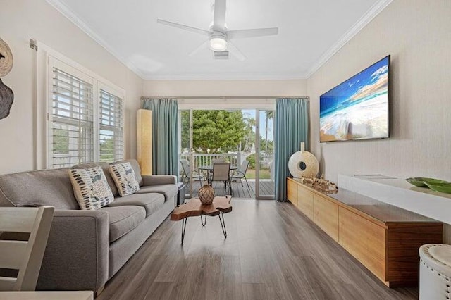 living room with dark hardwood / wood-style floors, crown molding, and plenty of natural light