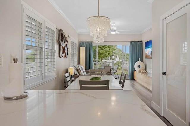 interior space featuring an inviting chandelier, ornamental molding, and wood-type flooring