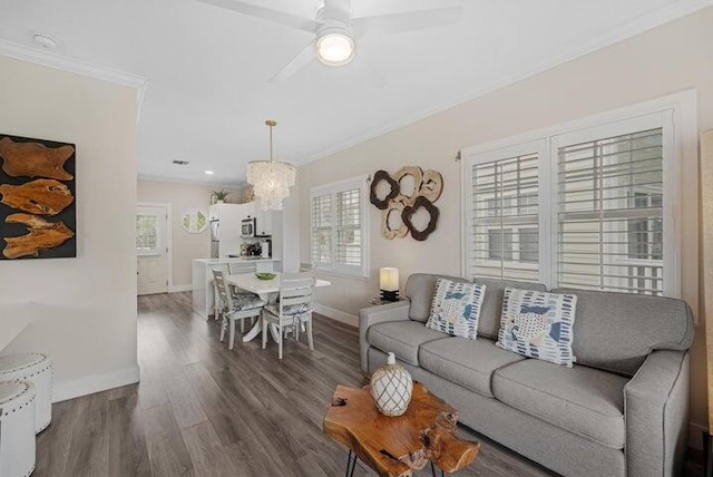 living room with ceiling fan, crown molding, and dark hardwood / wood-style floors