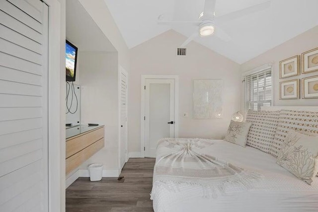 bedroom with ceiling fan, dark hardwood / wood-style flooring, and vaulted ceiling