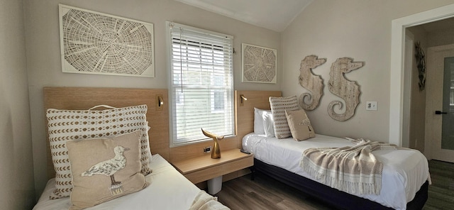 bedroom with lofted ceiling and dark hardwood / wood-style floors