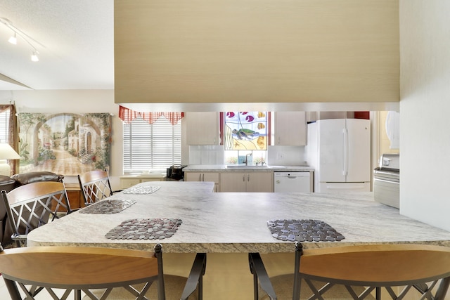 kitchen featuring white appliances and sink