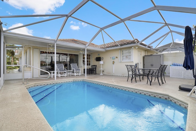 view of swimming pool featuring a patio and a lanai