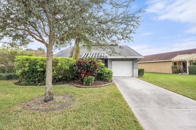 view of front of home with a garage and a front lawn