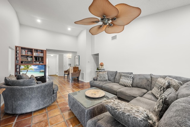 living room featuring tile patterned flooring, ceiling fan, and high vaulted ceiling