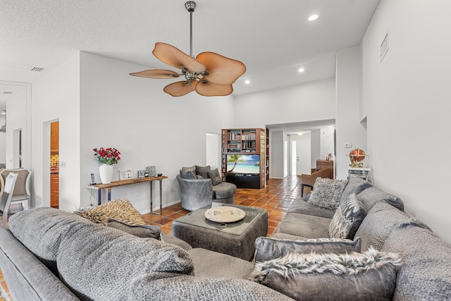 tiled living room featuring a high ceiling and ceiling fan