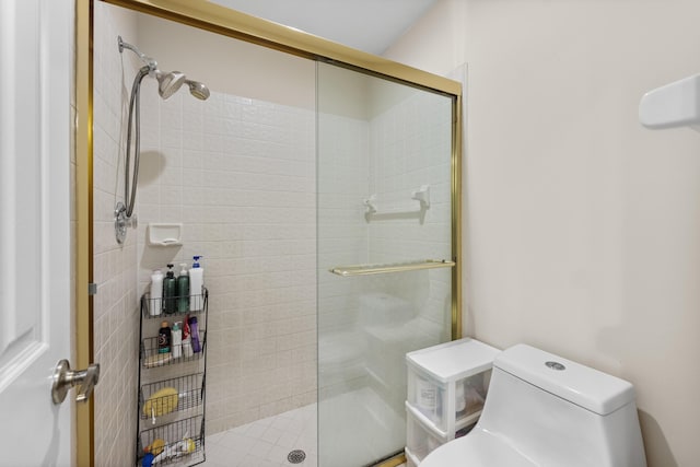 bathroom with toilet and an enclosed shower