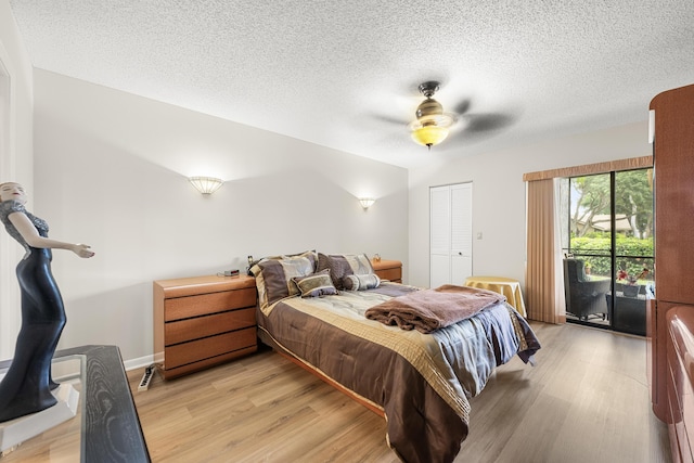 bedroom featuring access to exterior, ceiling fan, a textured ceiling, a closet, and light wood-type flooring