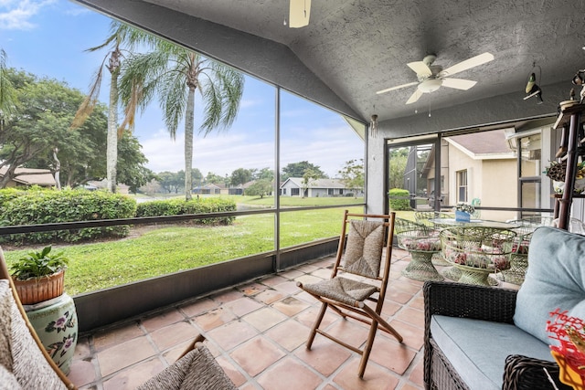 sunroom featuring ceiling fan and vaulted ceiling