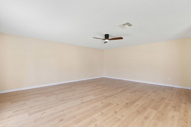 spare room featuring ceiling fan, a textured ceiling, and light hardwood / wood-style flooring