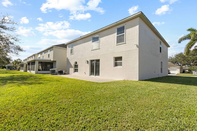 back of house featuring a sunroom, a yard, cooling unit, and a patio