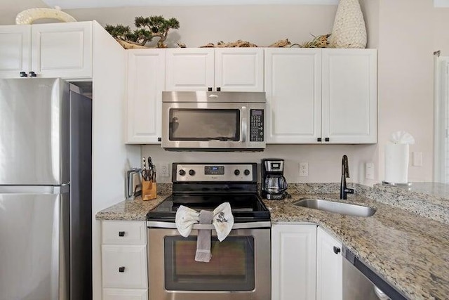 kitchen with sink, white cabinets, and appliances with stainless steel finishes