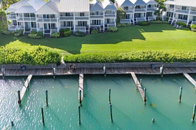 exterior space with a water view and a lawn