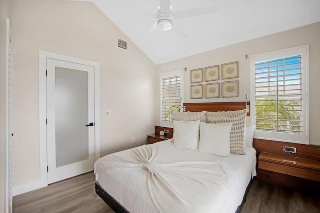 bedroom with ceiling fan, wood-type flooring, and lofted ceiling