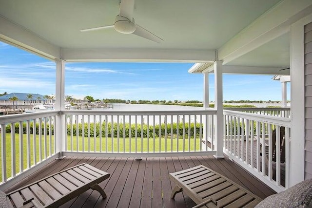 deck featuring ceiling fan and a yard