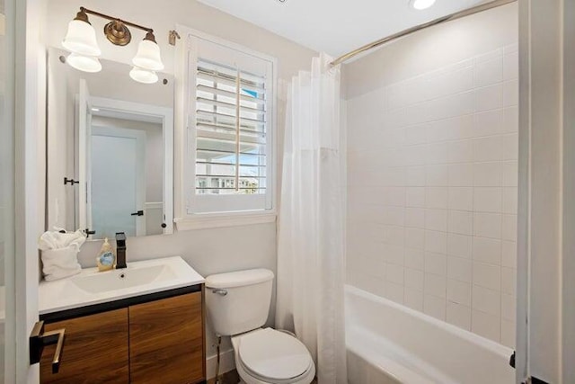 full bathroom featuring toilet, vanity, and shower / bath combination with curtain