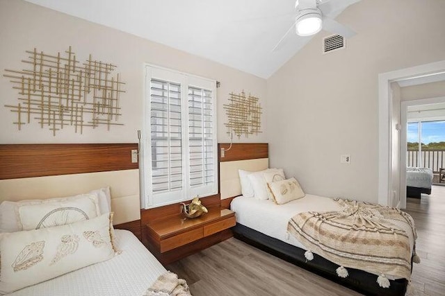 bedroom featuring vaulted ceiling, ceiling fan, access to exterior, and wood-type flooring