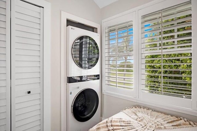 washroom featuring stacked washer / dryer