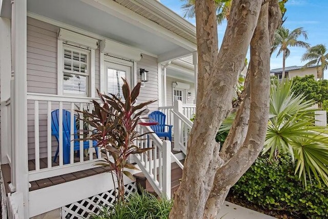 view of exterior entry featuring covered porch