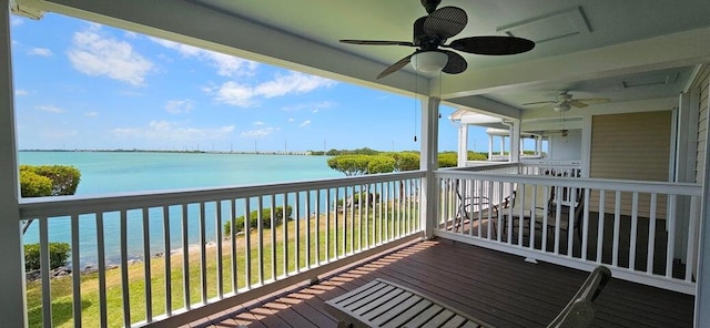 wooden deck featuring ceiling fan and a water view