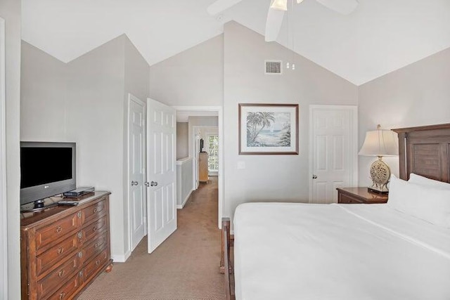 bedroom featuring vaulted ceiling, ceiling fan, and light carpet