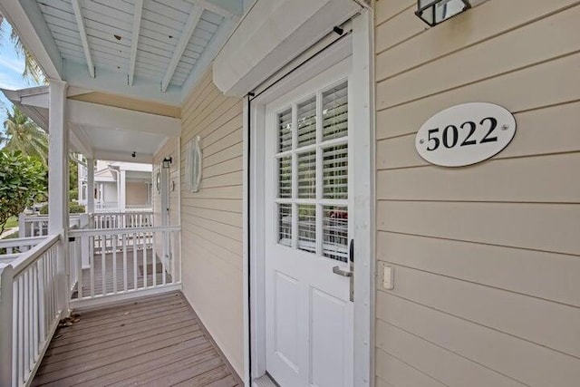 view of exterior entry featuring a porch