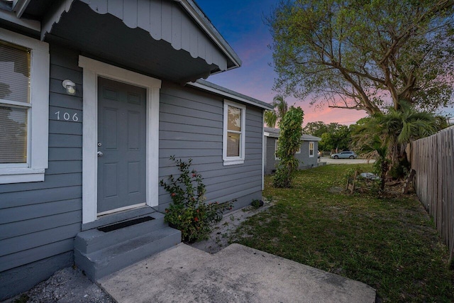 exterior entry at dusk with a yard