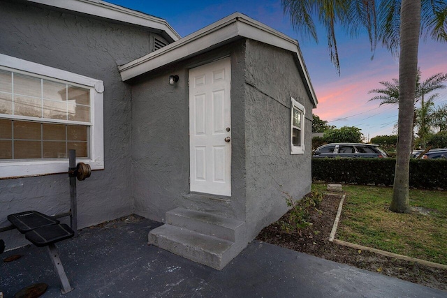 view of exterior entry at dusk