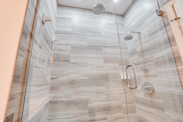 bathroom with a shower with shower door