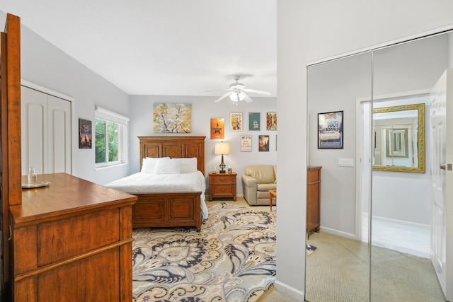 bedroom featuring ceiling fan, a closet, and light colored carpet