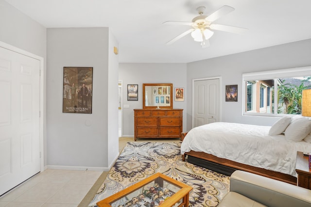 bedroom with ceiling fan, a closet, and light tile patterned floors