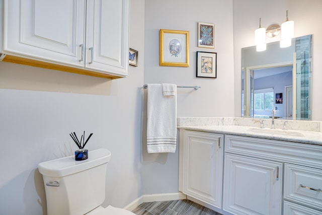 bathroom featuring vanity and toilet