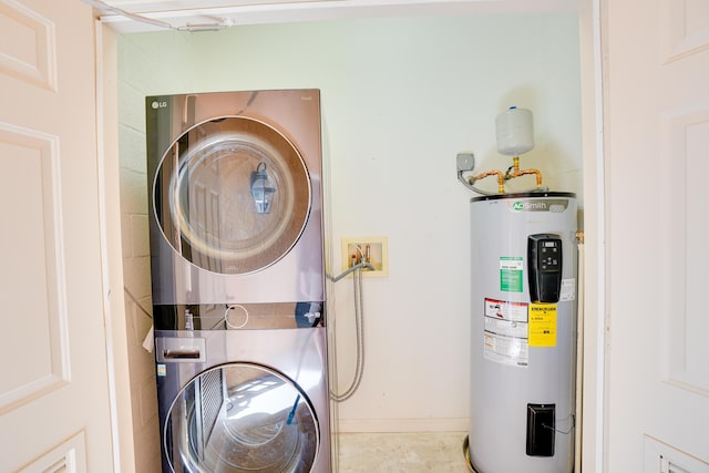 clothes washing area featuring stacked washer and clothes dryer and water heater