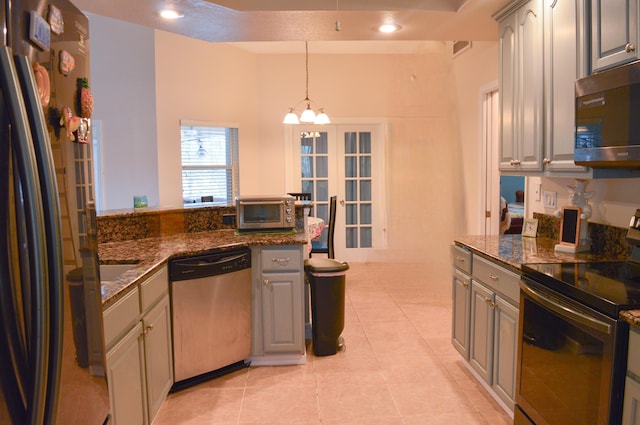 kitchen featuring gray cabinets, light tile patterned floors, and appliances with stainless steel finishes