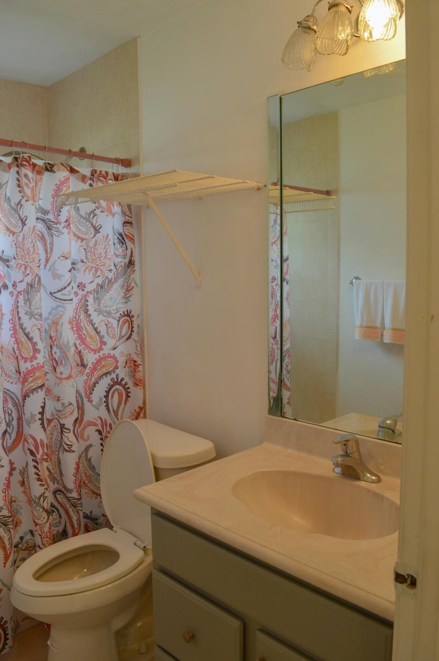 bathroom featuring vanity, curtained shower, and toilet