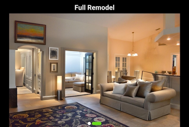 living room featuring an inviting chandelier, french doors, and light hardwood / wood-style flooring