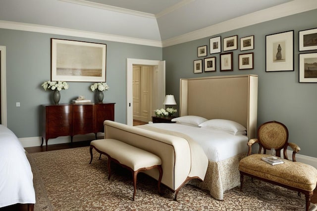 bedroom featuring hardwood / wood-style floors, lofted ceiling, and crown molding