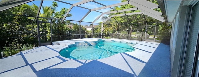 view of swimming pool with a patio area and a lanai