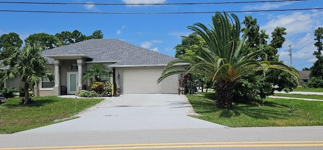 view of front of property featuring a garage and a front lawn