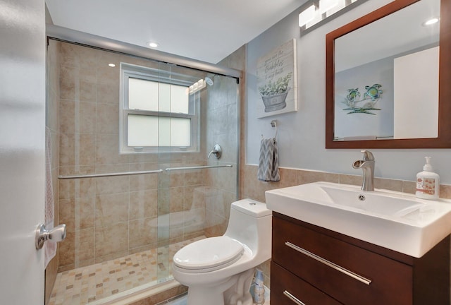 bathroom with vanity, toilet, and a shower with shower door