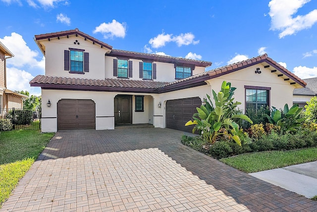 mediterranean / spanish house featuring a garage