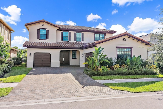 mediterranean / spanish-style house with a garage