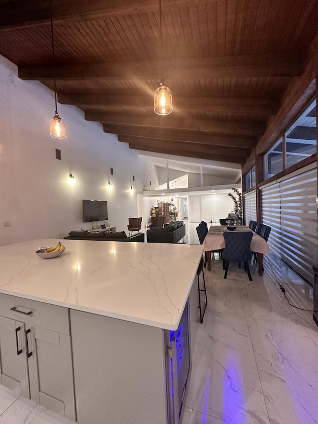 kitchen featuring lofted ceiling with beams, wood ceiling, marble finish floor, hanging light fixtures, and light stone countertops